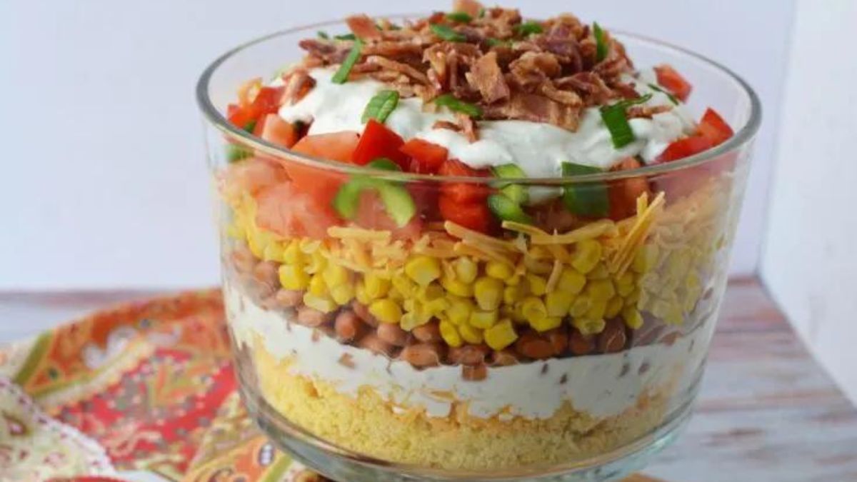 Cornbread salad layered in a trifle bowl.