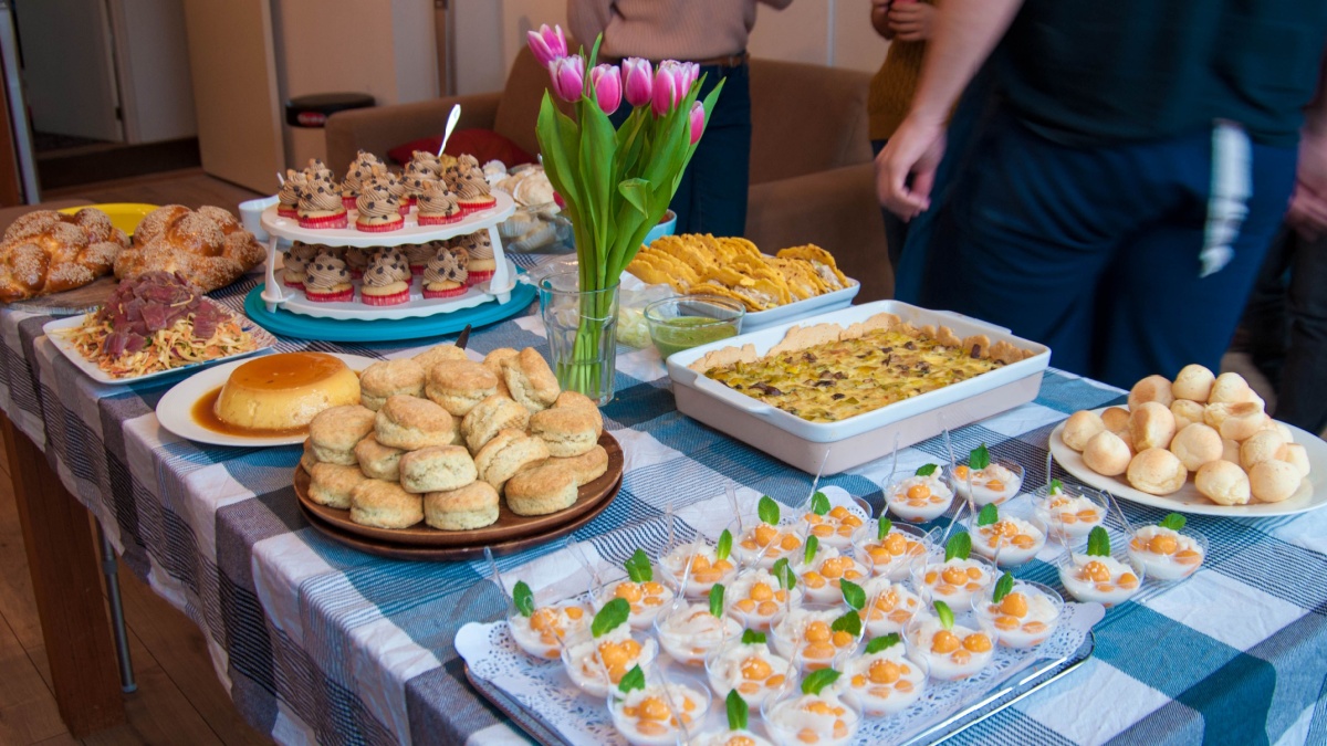 A potluck with different kind of homemade food on the table.