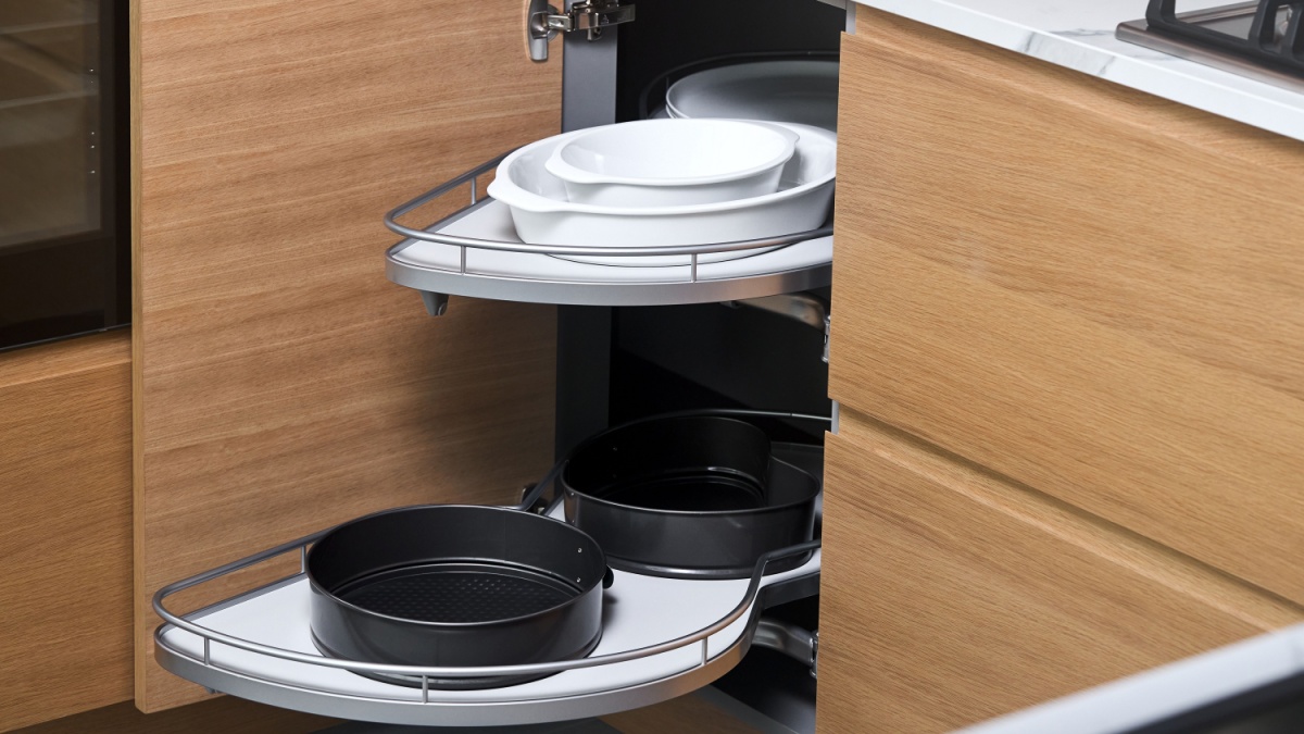 Kitchen access mechanism Magic corner for Blind Corner Cabinets. Solution for a kitchen corner storage in cupboard. Corner unit with pull out shelves for cookware.
