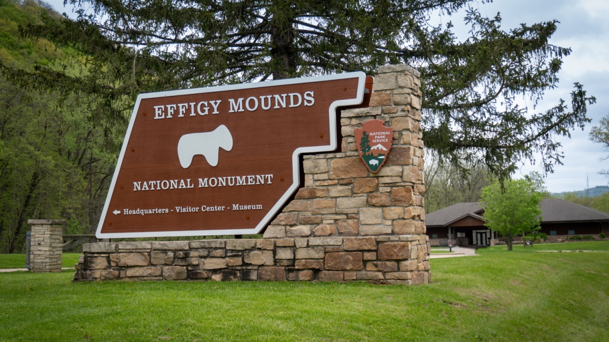Harpers Ferry, Iowa - May 1, 2023: Effigy Mounds National Monument sign. Site preserves prehistoric mounds built by pre-Columbian Mound Builder cultures. Some effigy mounds are shaped like animals..
