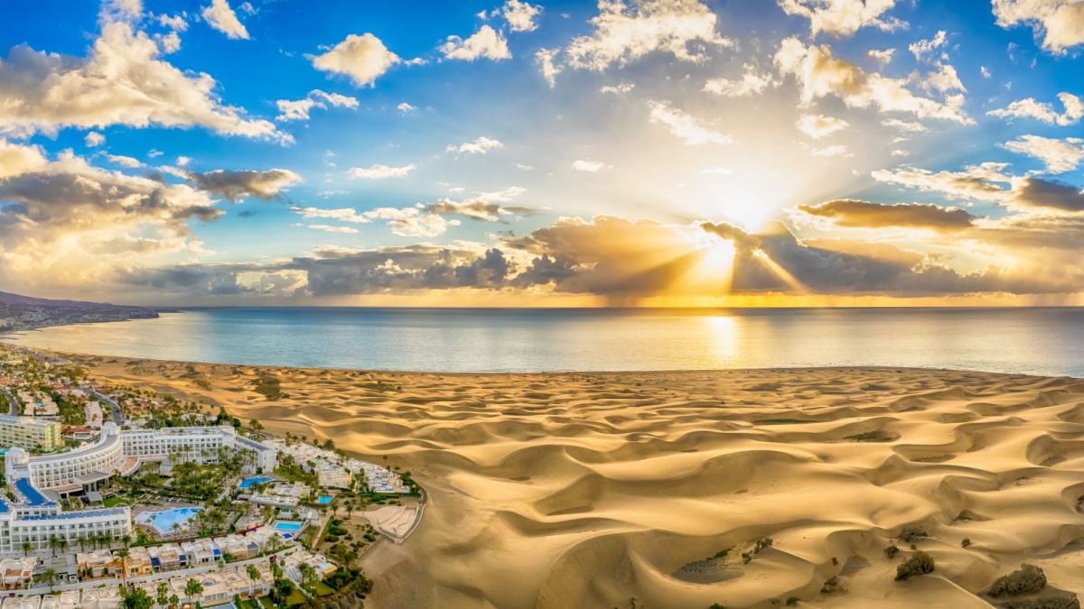 Landscape with Maspalomas town and golden sand dunes at sunrise, Gran Canaria, Canary Islands, Spain.