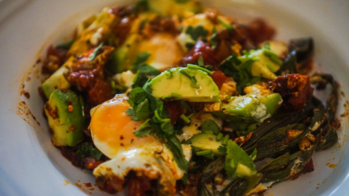 Spicy Shakshuka with Green Onion, Goat Cheese & Avocado Recipe.