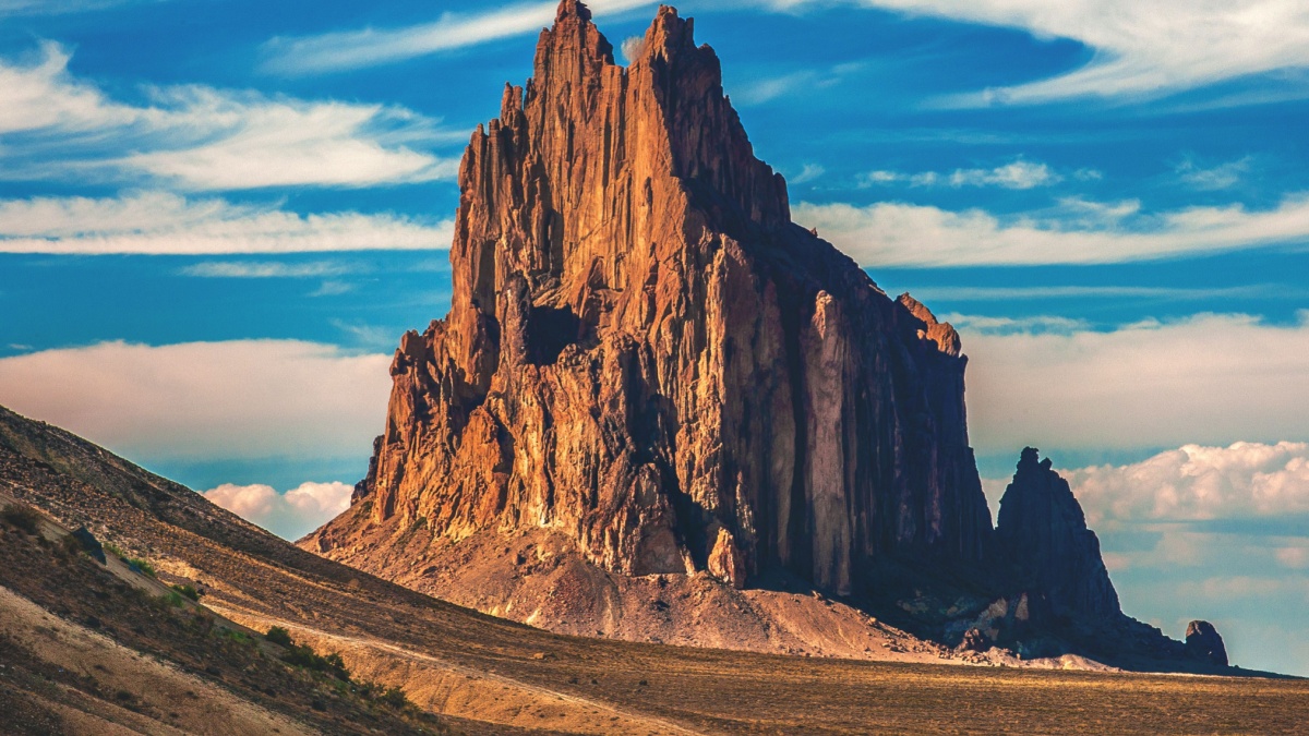 Shiprock, a remnant of an ancient volcano, sits in the middle of the desert on the Navajo Indian Reservation in the northwest corner of New Mexico in the United States.