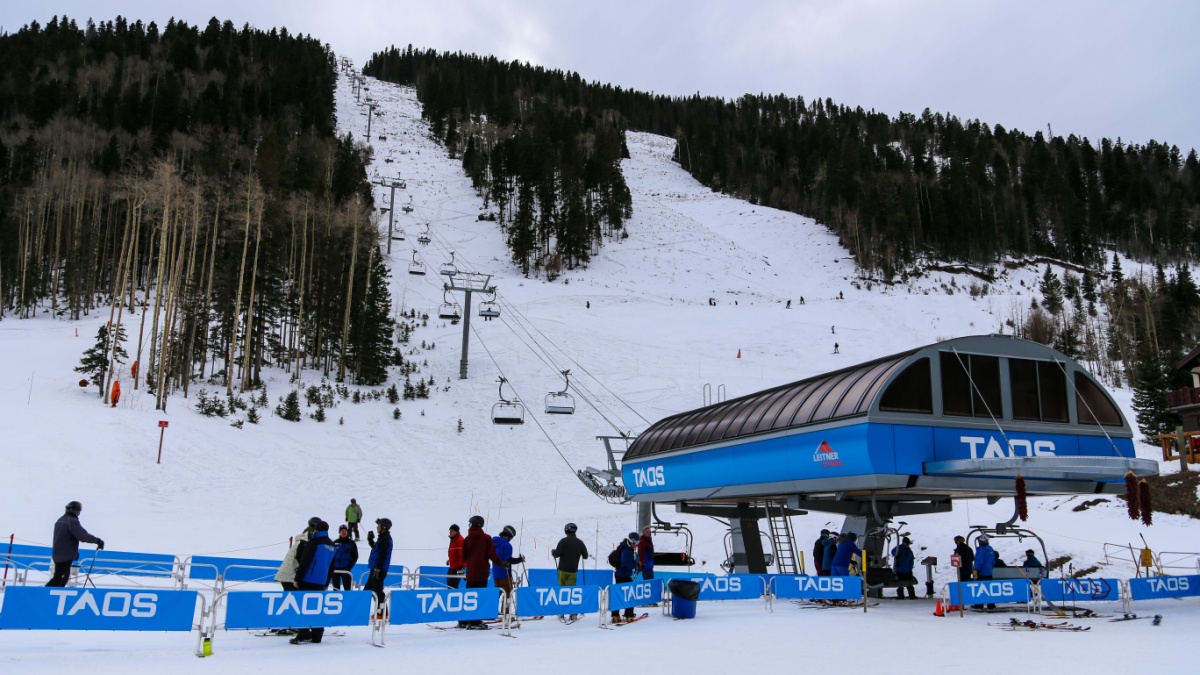 Taos, New Mexico / USA November 22, 2018 Ski lift and people waiting in line for the new quad lift at Taos Ski Valley resort.