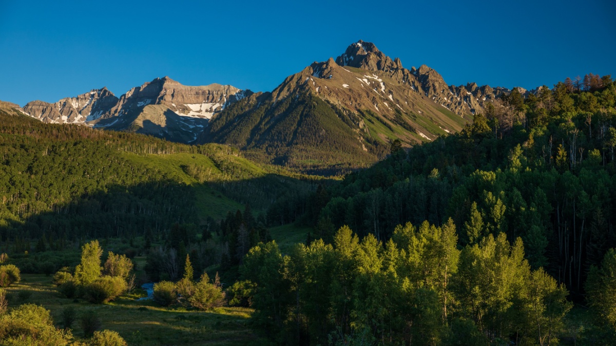 Mt Sneffels range with clear blue skies at sunset.