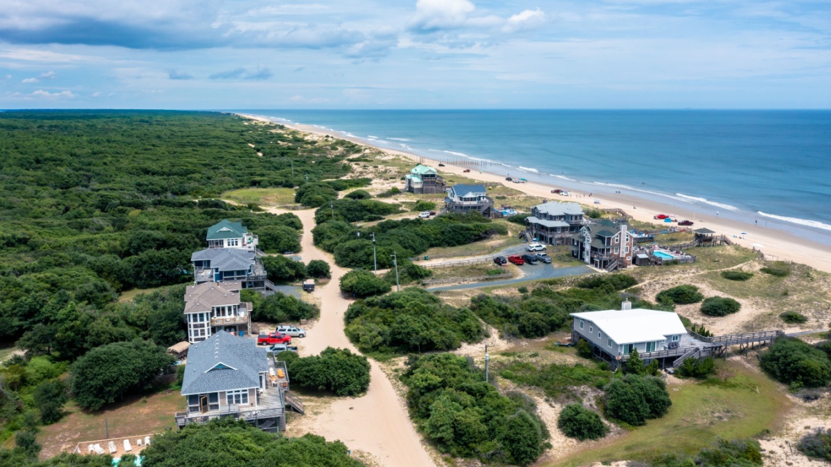 Carova Beach North Carolina - August 11 2022: Aerial View of beach homes in Carova North Carolina looking North towards False Cape State Park in Virginia Beach.