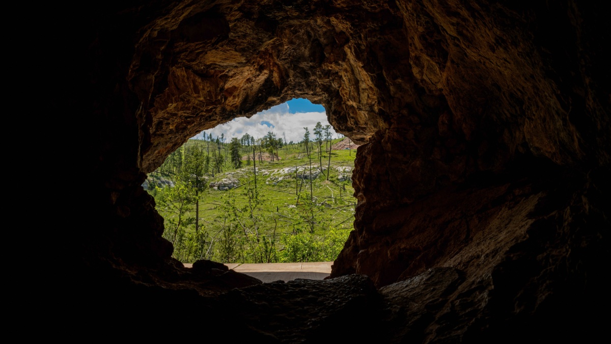 Jewel Cave National Monument Historic Site with outside hill view: The Beautiful Rock Formation and Opening at Custer State Park, Black Hills Country, South Dakota.