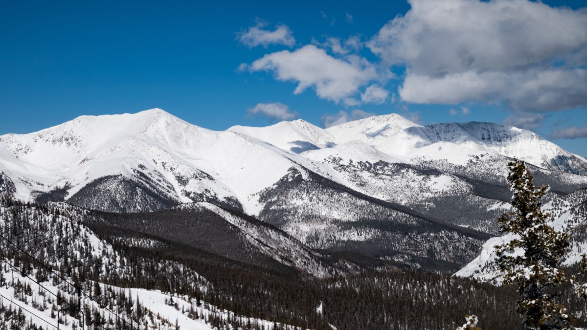 This is a photo from the highest point on monarch mountain ski resort in Salida, CO. It was taken during a clear day with the intent to capture the scale and beauty of the expansive mountain range.