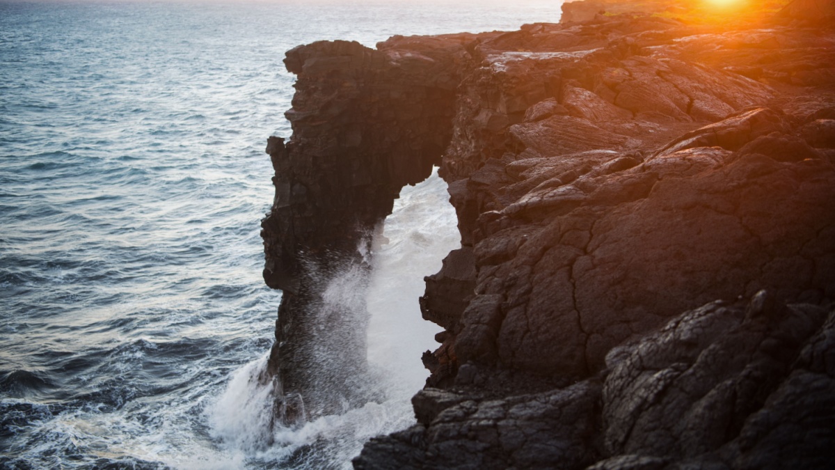 Holei Sea Arch at sunset. The natural arch is located at the end of the Chain of Craters Road and a highlight of the Volcanoes National Park on Hawai'i's Big Island.