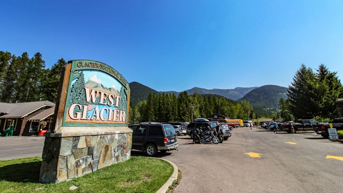 The sign and parking lot at the West Entrance to Glacier National Park in North Montana.