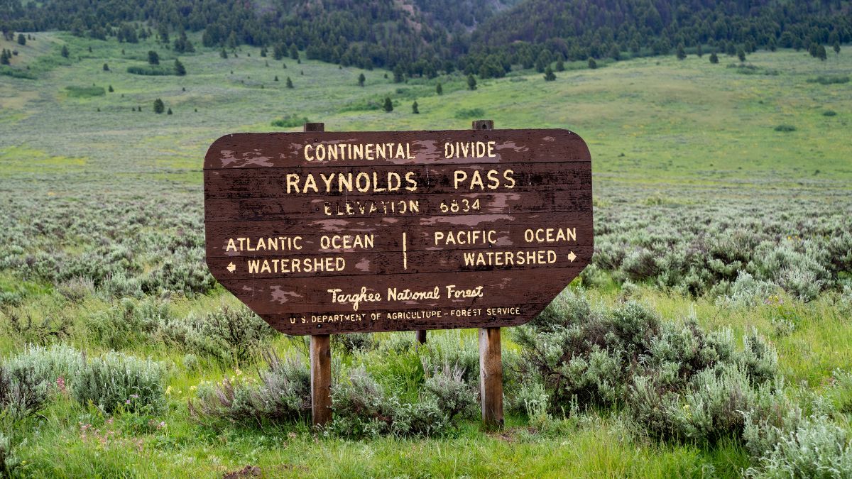 July 1, 2020 - Continental Divide, MT: Raynolds Pass sign in the Targhee National Forest on the Idaho and Montana border along Highway 87.