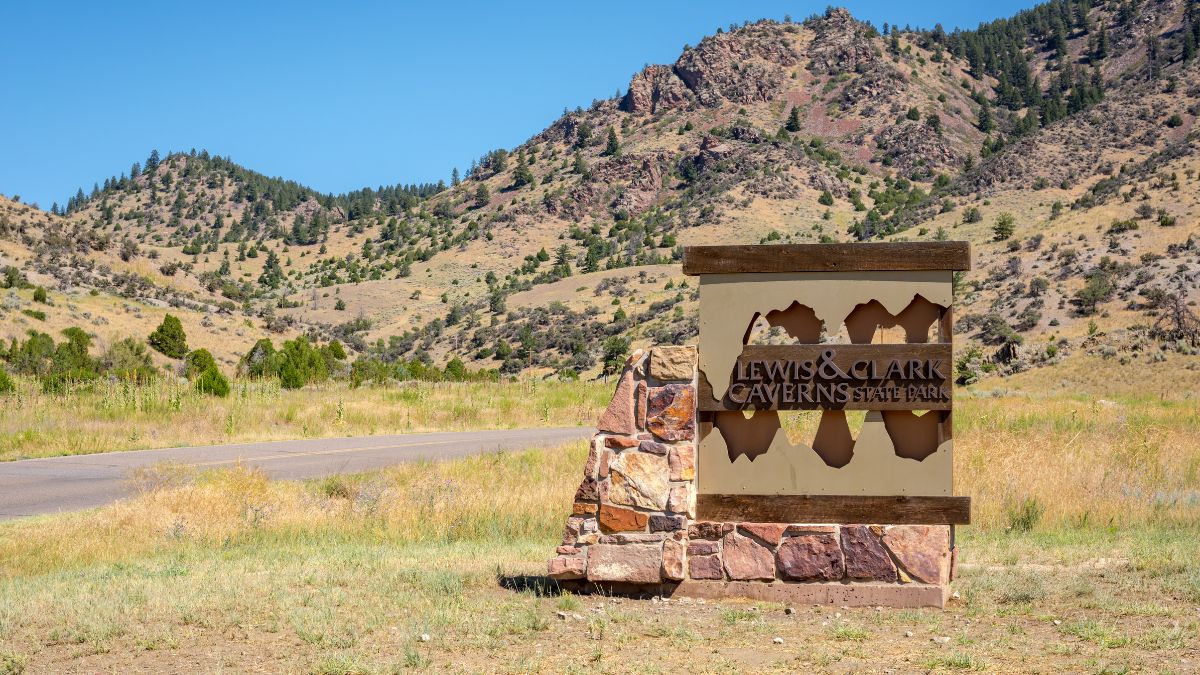 Montana, USA, July 27, 2016 - Sign & road mark the entrance to the famous & popular Lewis & Clark Caverns State Park which was Montanas first State park.