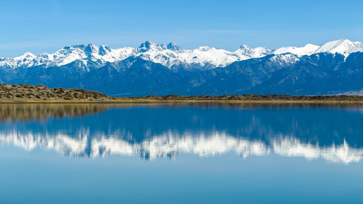 Sangre de Cristo Mountains - Panoramic view of Snow-capped Sangre de Cristo Mountains, including 14ers: Challenger Point, Kit Carson Peak, Crestone Peak, Crestone Needle, reflecting in San Luis Lake.