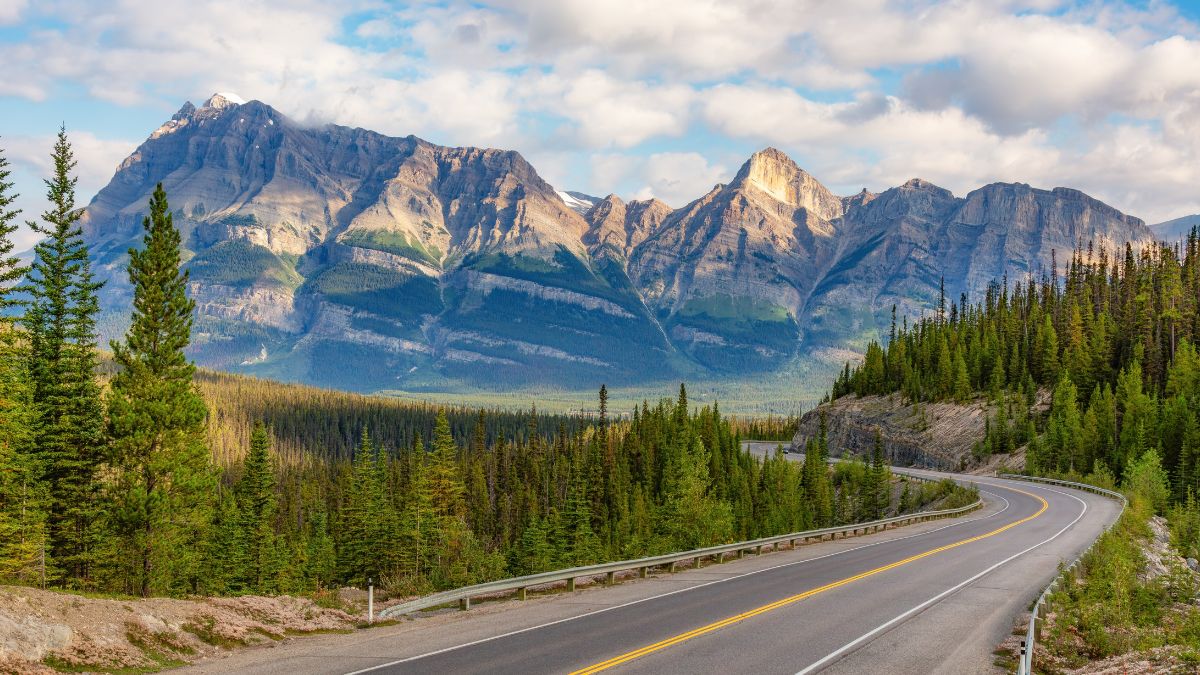 Scenic Highway in Canadian Rocky Mountains. Sunny Cloudy day. Banff, Alberta, Canada.