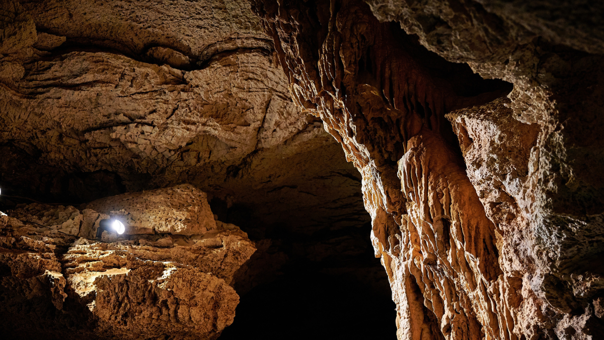 BURNET, TEXASUSA - JULY 3rd 2023: a family with a teenage girl on a road trip during school summer holidays, visiting Longhorn Cavern State Park with its intricate paths and natural stone works.
