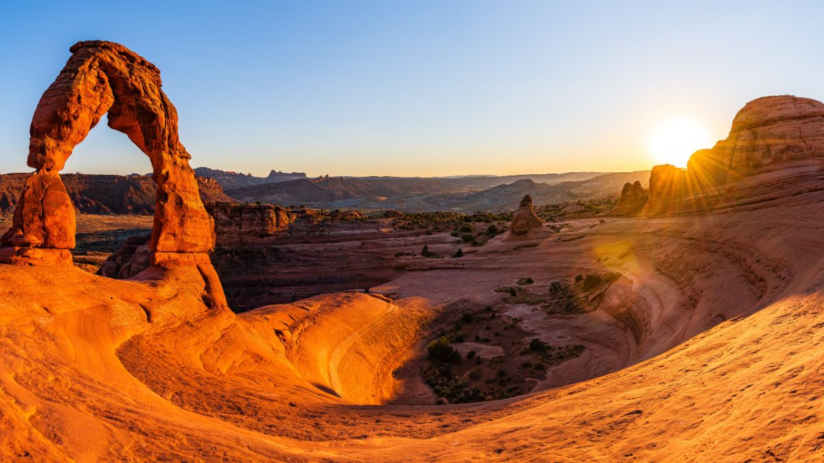 Delicate Arch - The most famous landmark of the Arches National Park in Utah in strong sunlight during sunset.