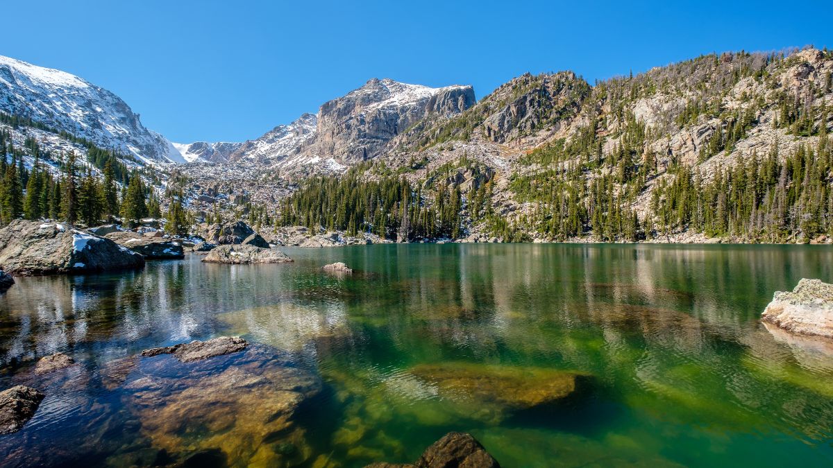 Lake Haiyaha with rocks and mountains in snow around at autumn. Rocky Mountain National Park in Colorado, USA.