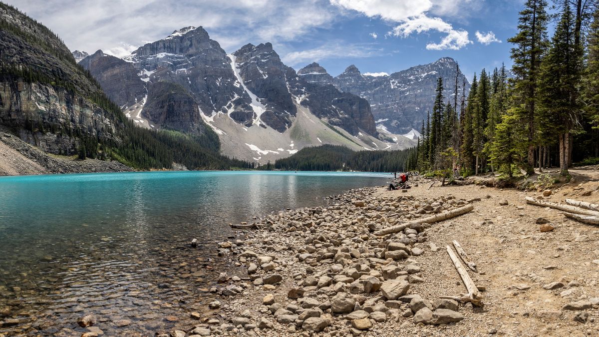 Panoramic view of azure blue coloured lake and mountains at Moraine Lake, Rocky Mountains, Alberta, Canada on 5 June 2023.