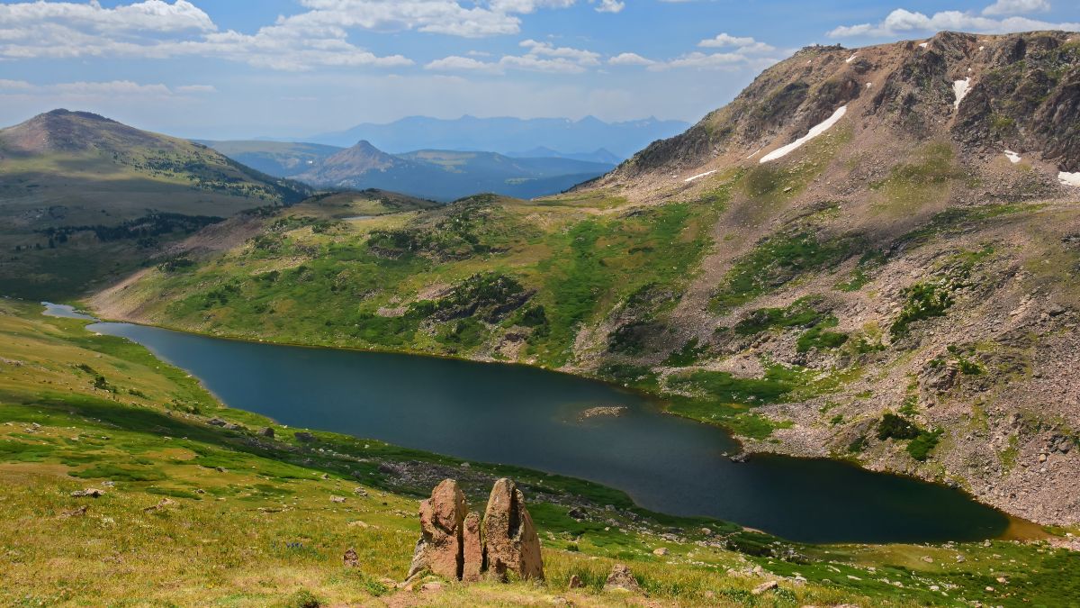 beautiful gardner lake, boulders, mountain peaks, and valley on a sunny summer day along the beartooth highway, a national scenic byway in wyoming.