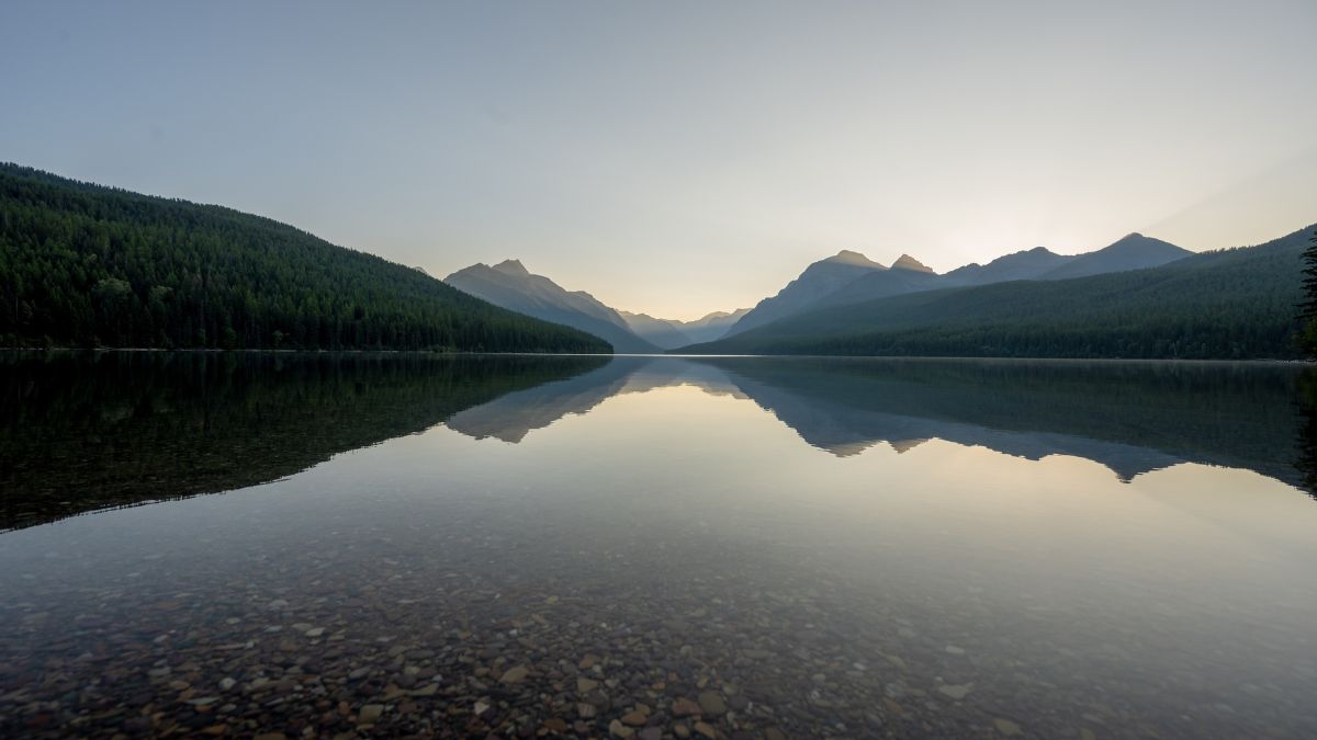 Flat Waters of Bowman Lake as Daylight Begins in Glacier.